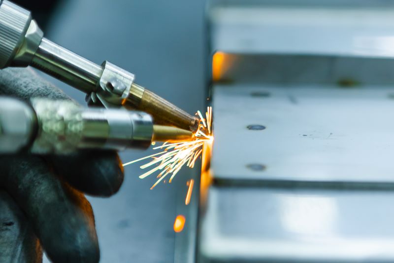 solda a laser: close de soldagem a laser em peça metálica